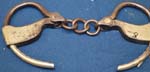 pair%20of%20steel%20handcuffs%20with%20inside%20ratchet%20and%20chain%20links